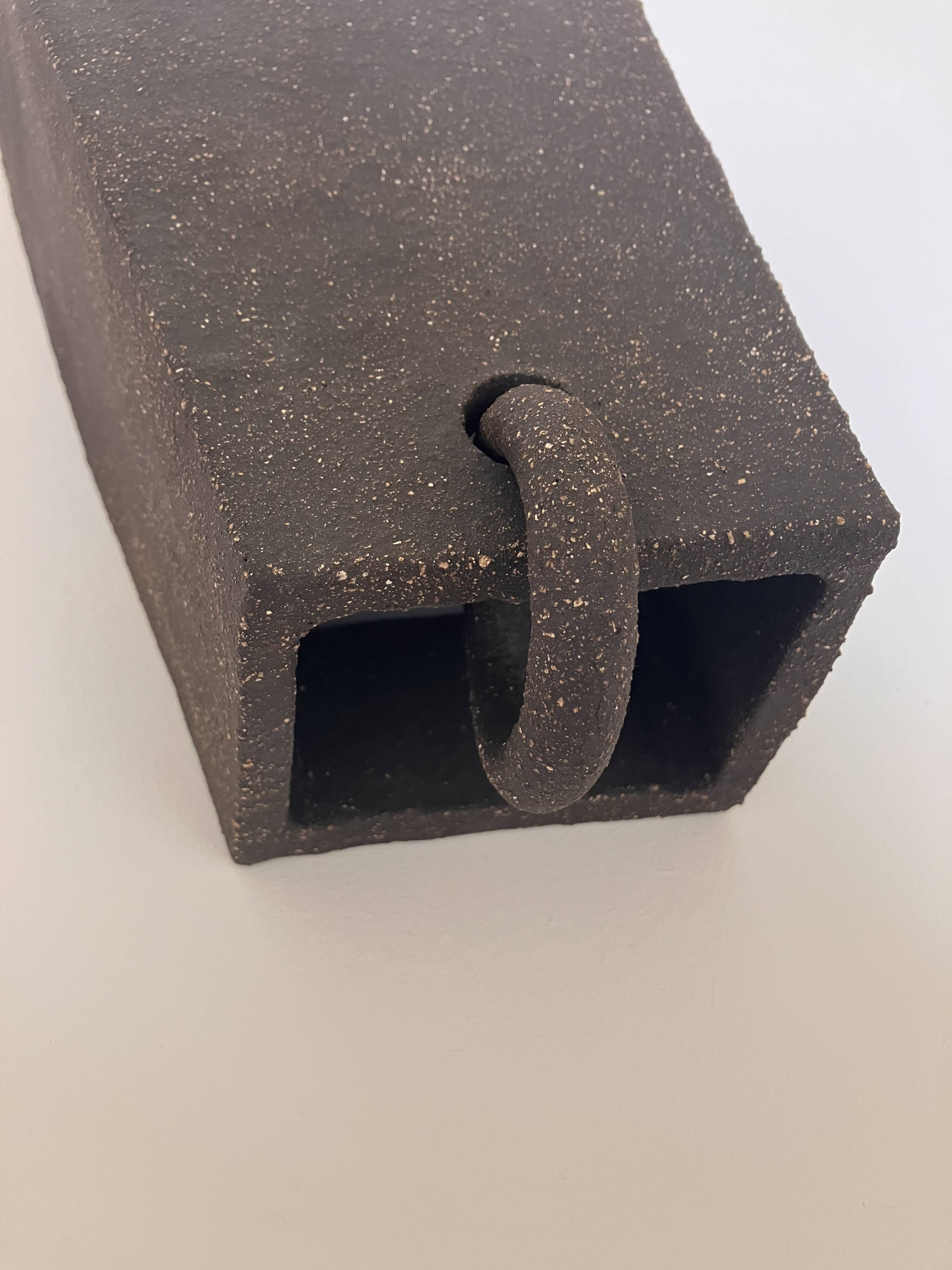 Graphical black stoneware ceramic wall light with handmade ring.