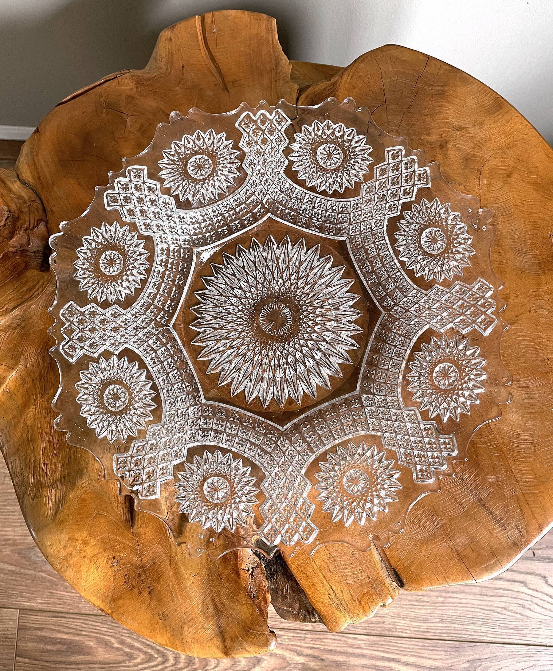 Vintage pressed glass plate with rosette design, octagonal rim, star pattern reminiscent of mandala