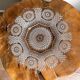 Vintage pressed glass plate with rosette design, octagonal rim, star pattern reminiscent of mandala