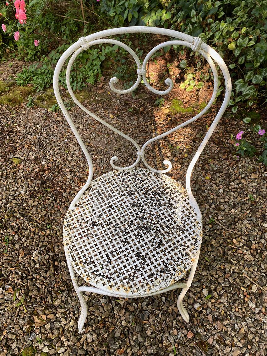 Part of a white lacquered wrought iron garden furniture set