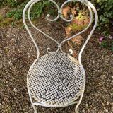 Part of a white lacquered wrought iron garden furniture set