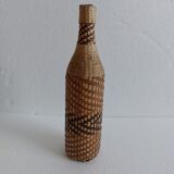 Old bottle dressed in wicker