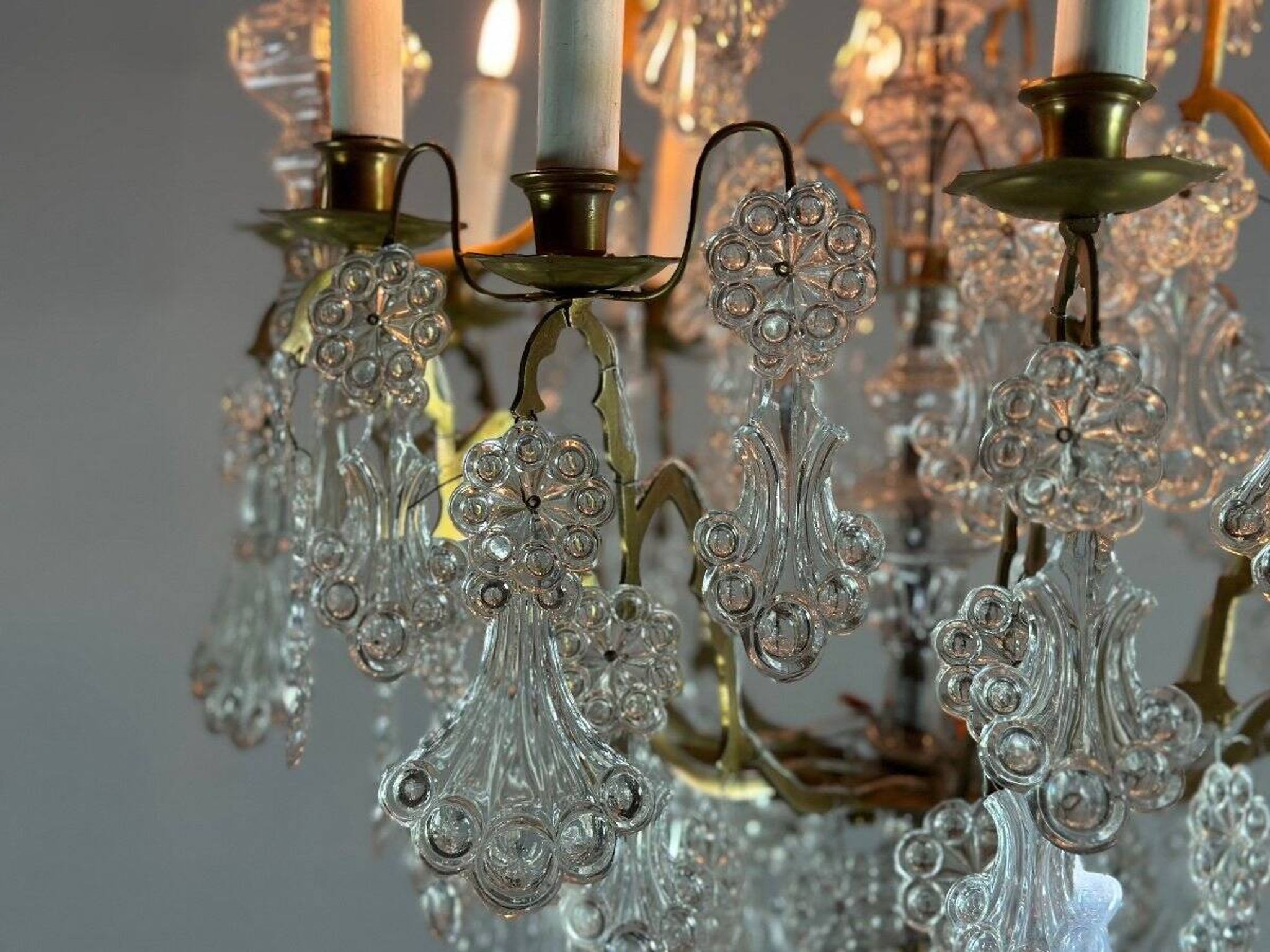 Bronze cage chandelier adorned with molded glass pendants in the shape of peacock feathers, circa 1800