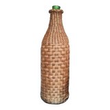 Green glass bottle and wickerwork