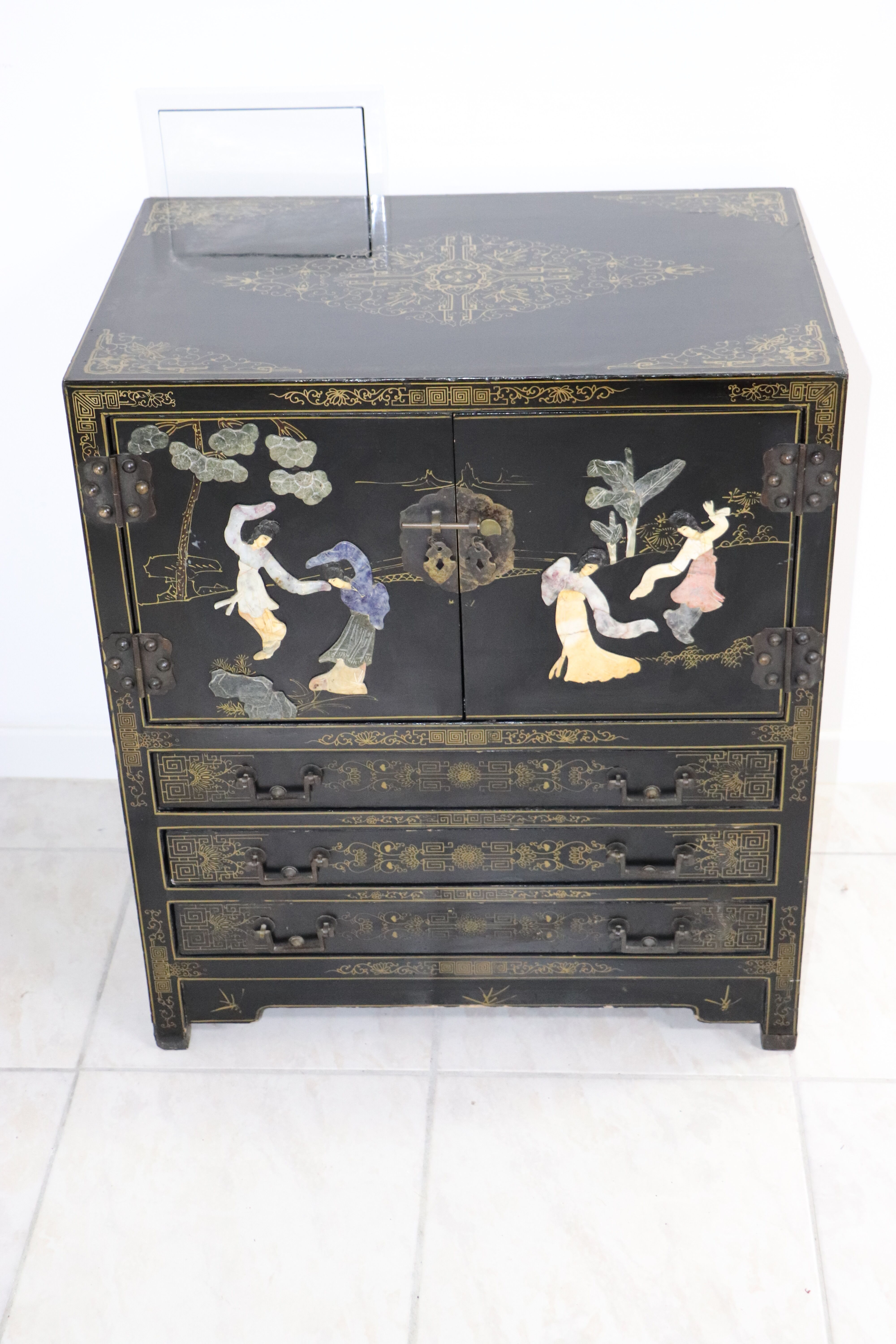 Black lacquered Chinese buffet with stone and ivory figures