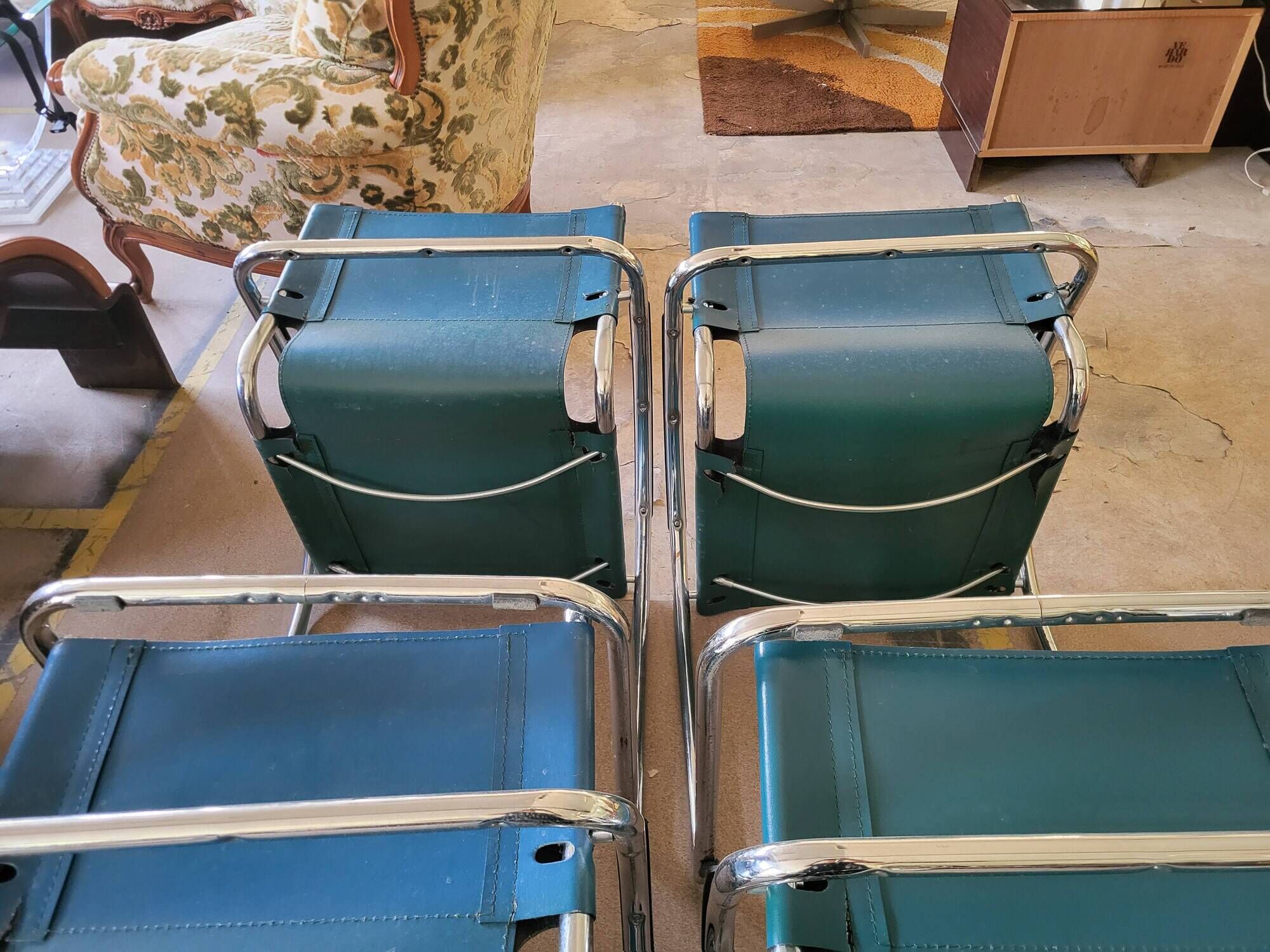 4 vintage Italian armchairs in green leather and chrome metal.