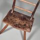 Rustic Wabi-Sabi style accent chair in dark curved hardwood, 1900s.