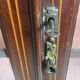Antique English display cabinet. Marquetry with floral patterns and ribbons.