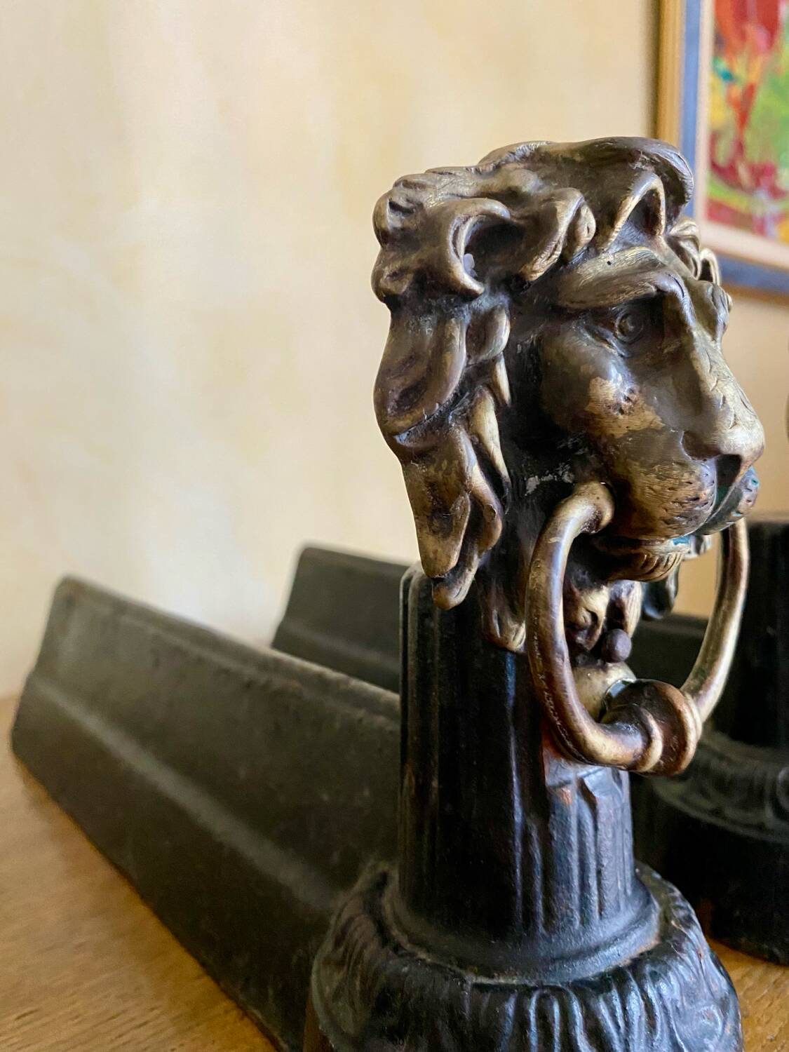 Pair of antique fire dogs with lion heads - patinated cast iron