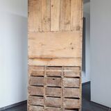 Craft cabinet with drawers with a very old tobacco advertisement in the background