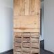 Craft cabinet with drawers with a very old tobacco advertisement in the background