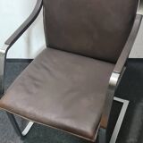 One of two vintage Leather and metal arm chairs.