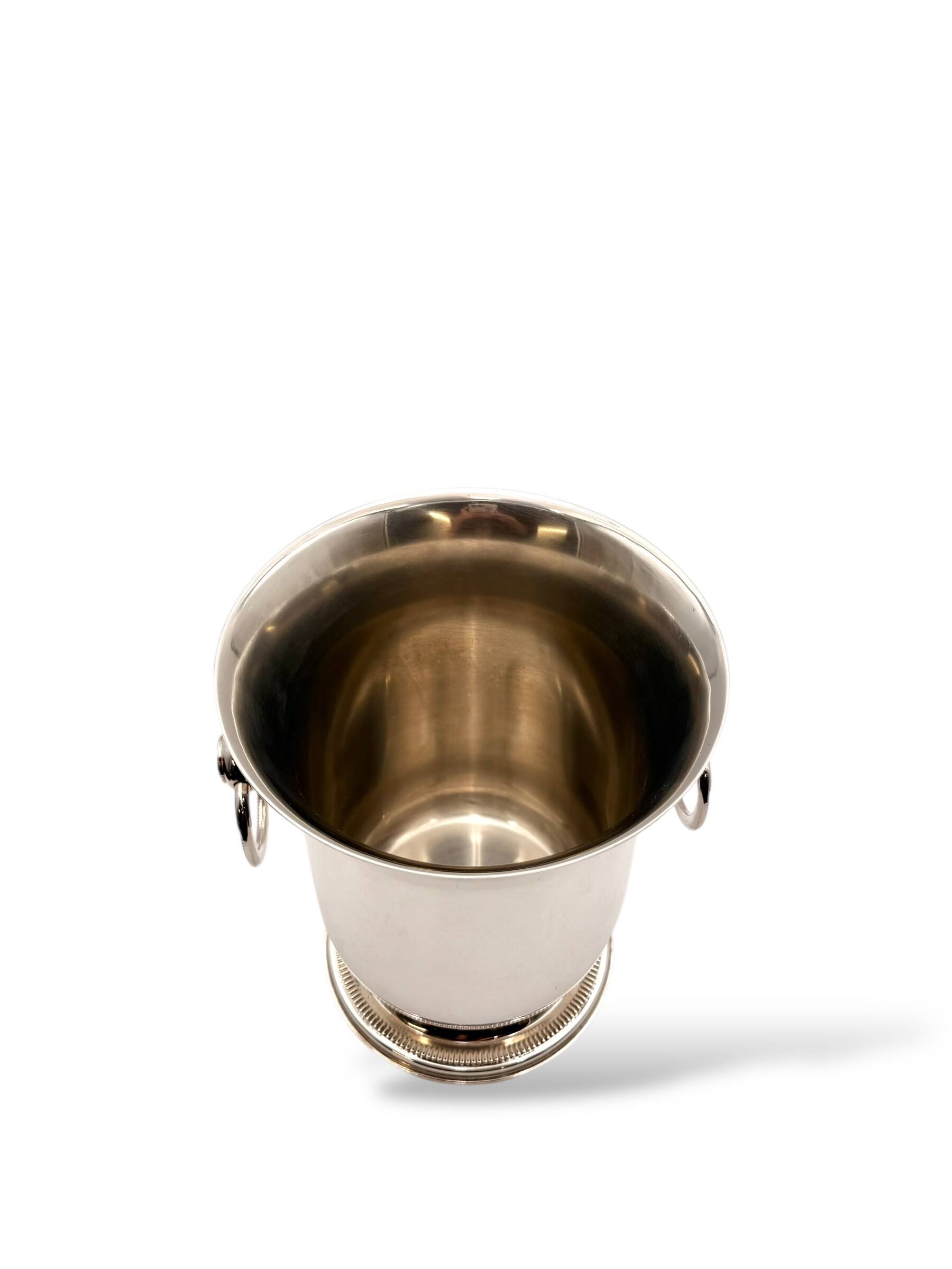 Silver-plated champagne bucket with ring handles.