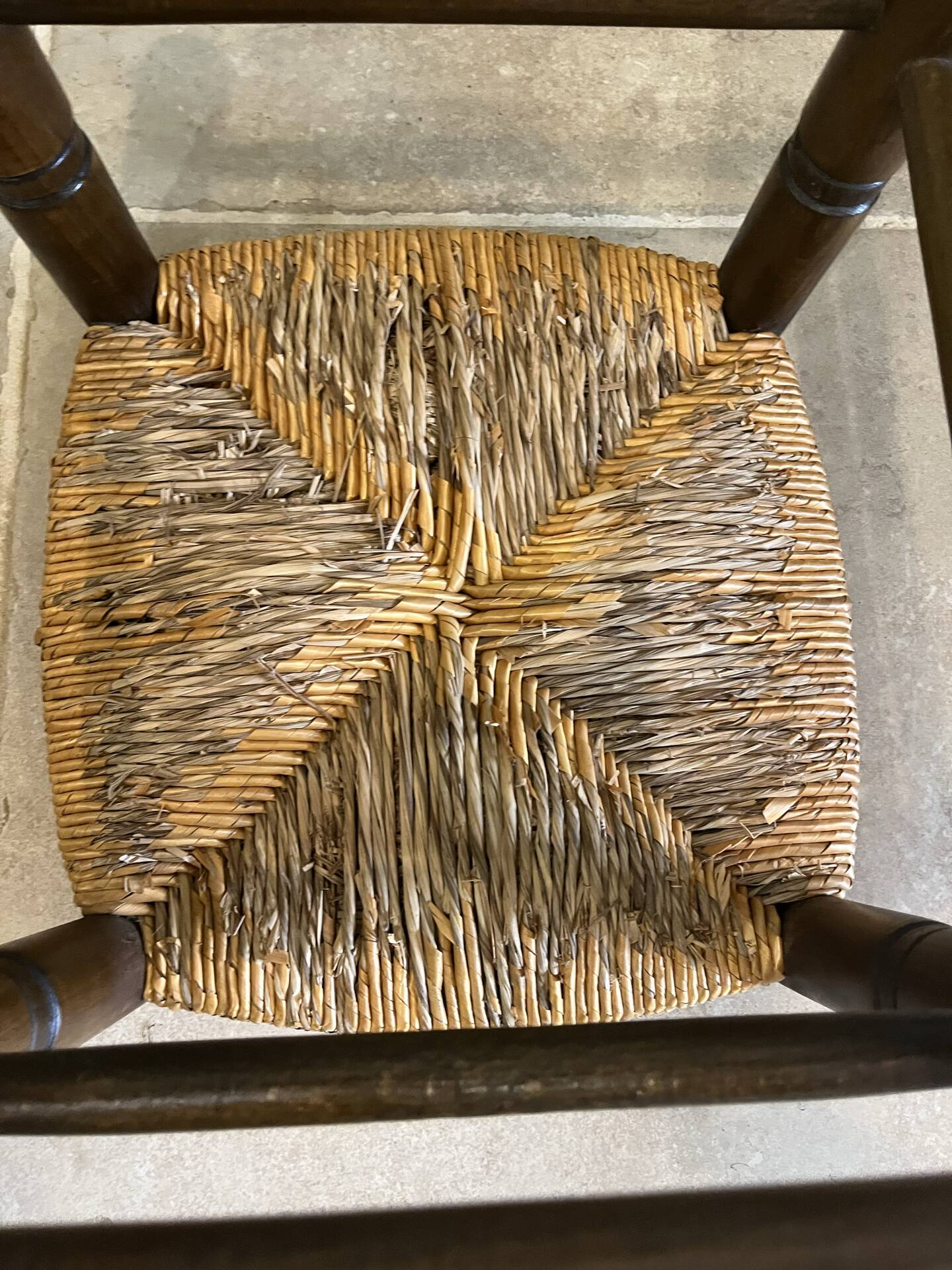 Wooden stool with a straw seat