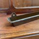 Antique wooden coat rack with mirror and shelf.