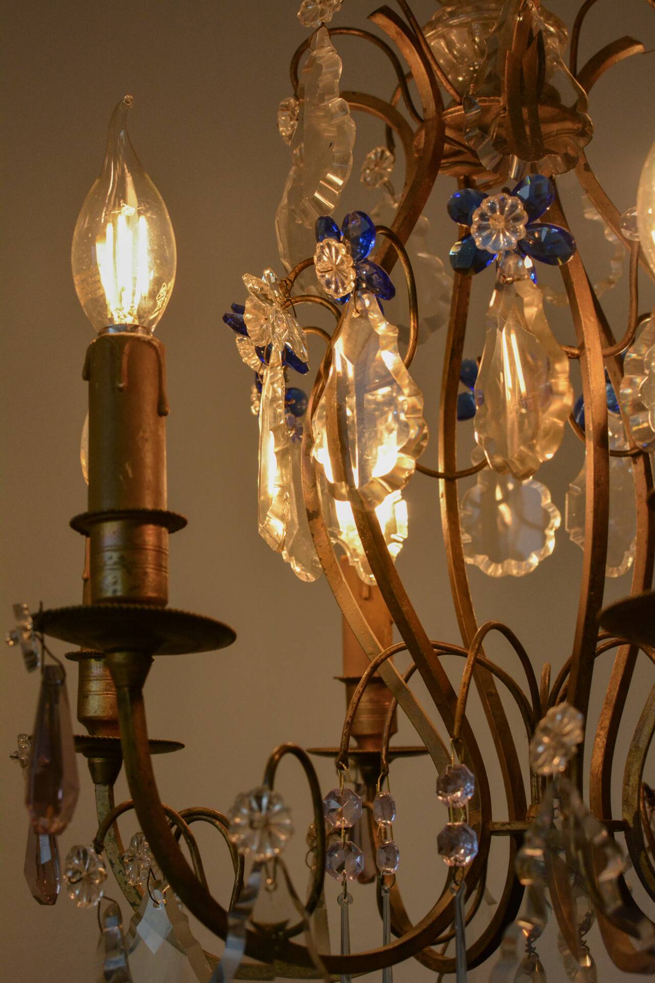 Antique French chandelier cage in gilded bronze and crystal, with blue pendants.