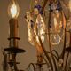 Antique French chandelier cage in gilded bronze and crystal, with blue pendants.