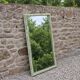 Large antique bevelled mirror in carved solid wood, green lizard – 129 × 75