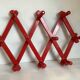Red wood accordion coat rack