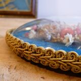 Oval frame bouquet of dried flowers with curved glass