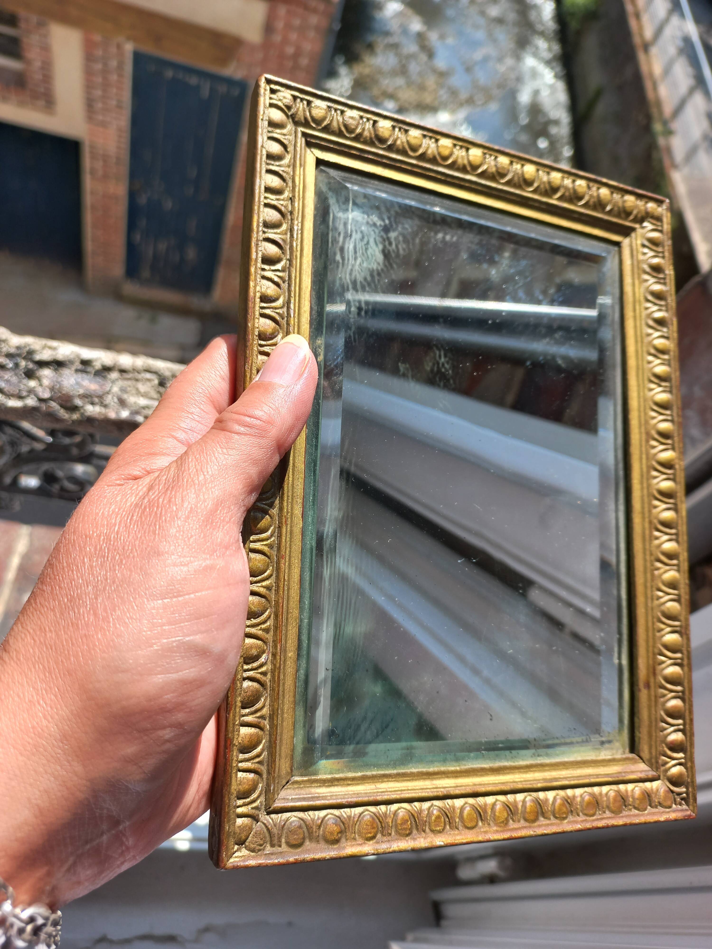 Small vintage mirror in gilded wood, bevelled glass with chain.