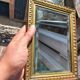 Small vintage mirror in gilded wood, bevelled glass with chain.