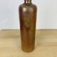 Stoneware bottle lamp and vintage wool lampshade