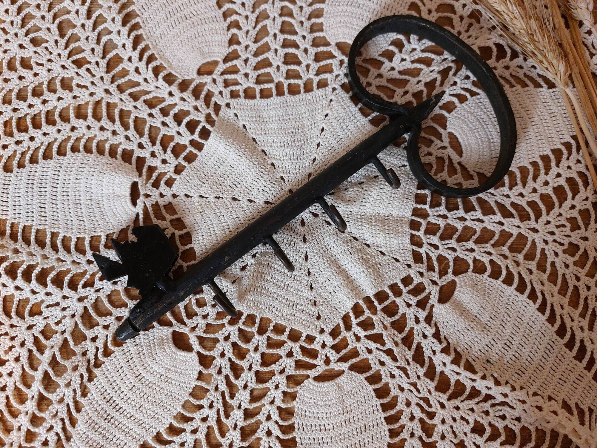 Old wall key holder in the shape of a vintage metal key 4 hooks