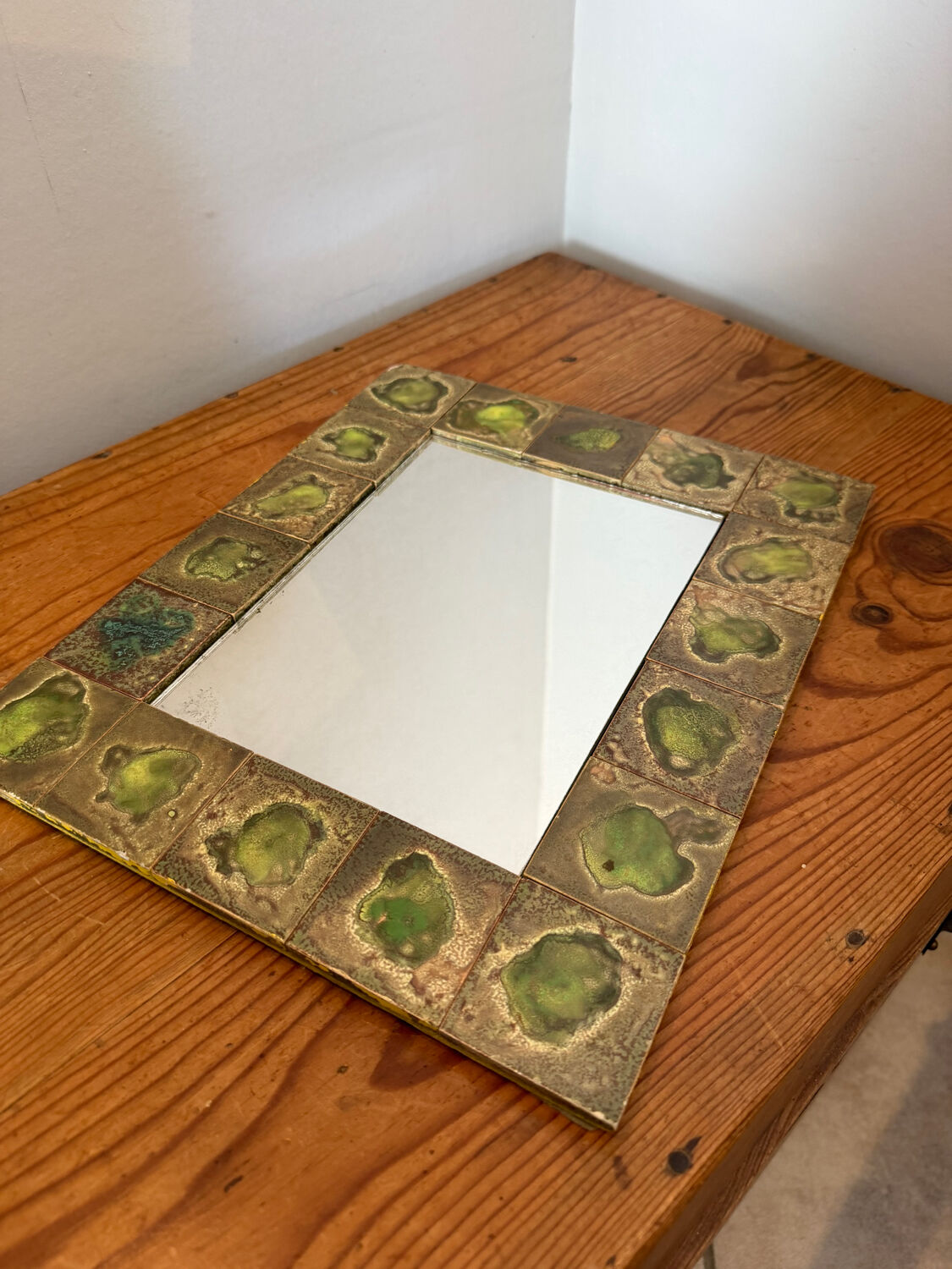 Vintage 1960s green and brown glazed ceramic mirror.