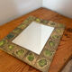 Vintage 1960s green and brown glazed ceramic mirror.