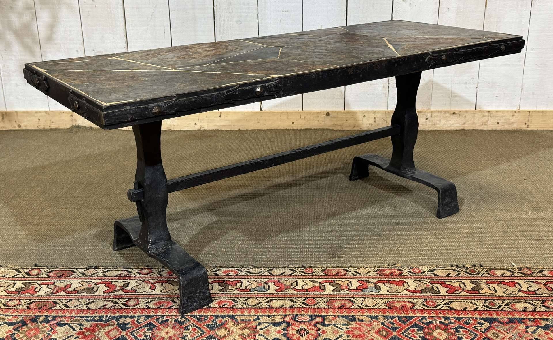 Coffee table in wrought iron with a slate top, work from the 1950s.