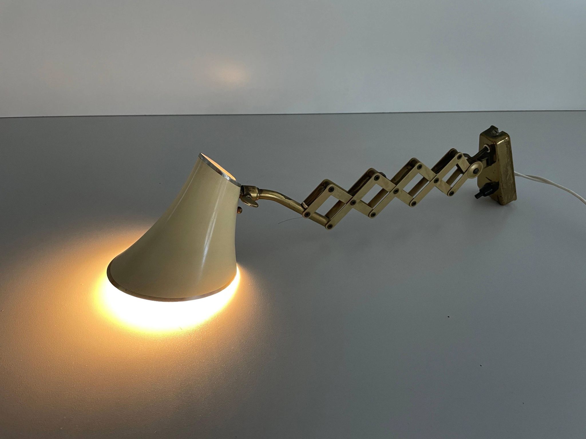 Cream metal and brass wall lamp with scissors design by Karl Lang for SIS Licht, 1950s, Germany.