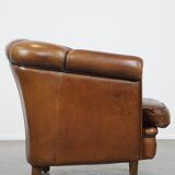 Unique vintage cognac-coloured leather club armchair with black piping