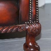 Restored Victorian sofa in leather with claw feet and feather cushions.