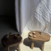 Small stool, oval solid teak side table with curved legs in wabi-sabi style.
