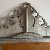 Large antique baroque mirror with angel decorations.