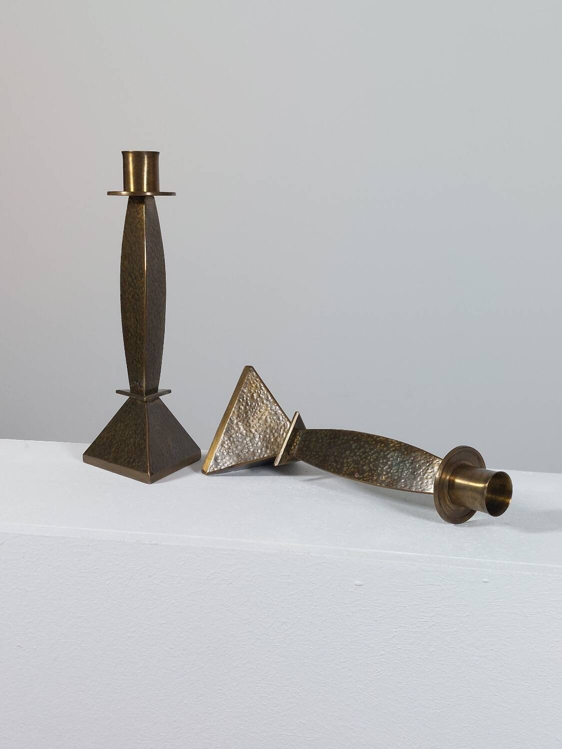 Pair of hand-hammered brass candlesticks in Memphis style.