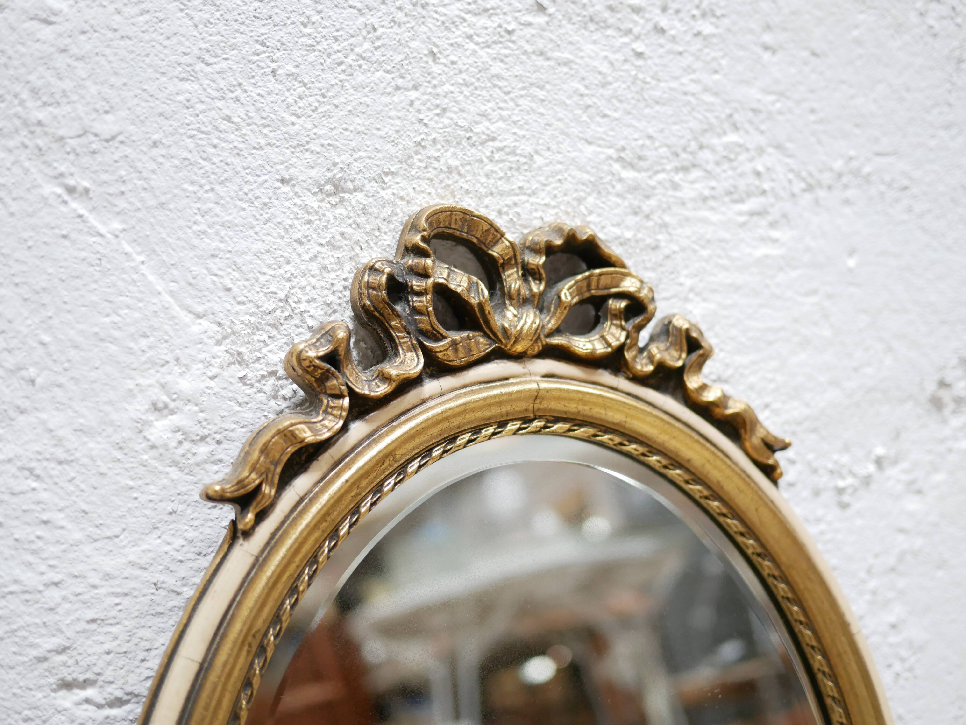 Old oval mirror Louis XVI style in gilded wood 50cm x 34cm