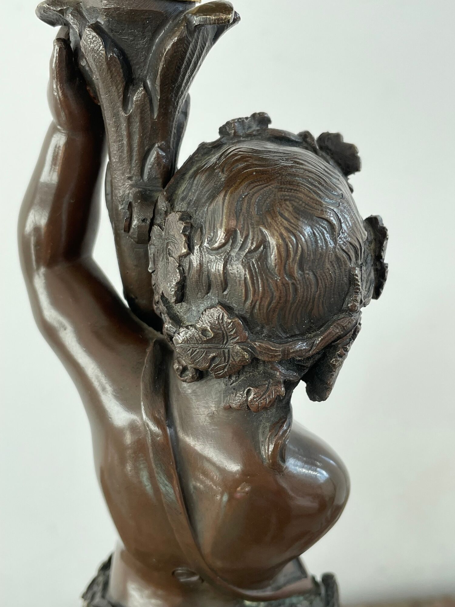 Candelabra with cherub in patinated bronze