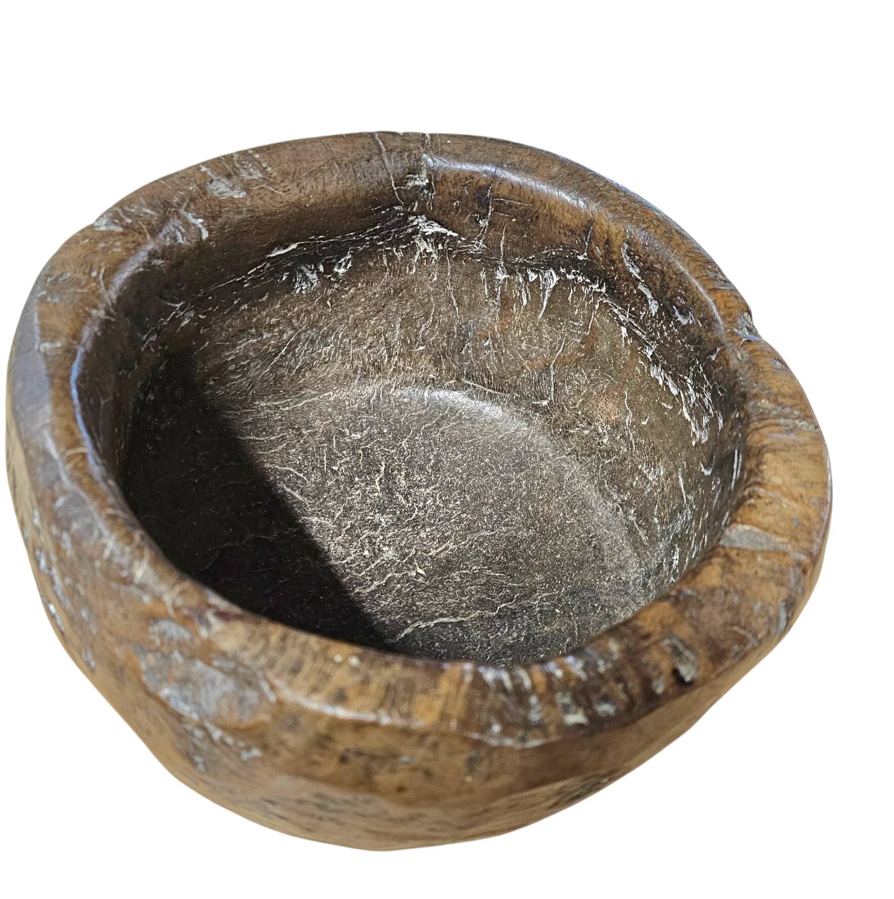 A substantial hand-hewn wooden bowl carved from a single burl section