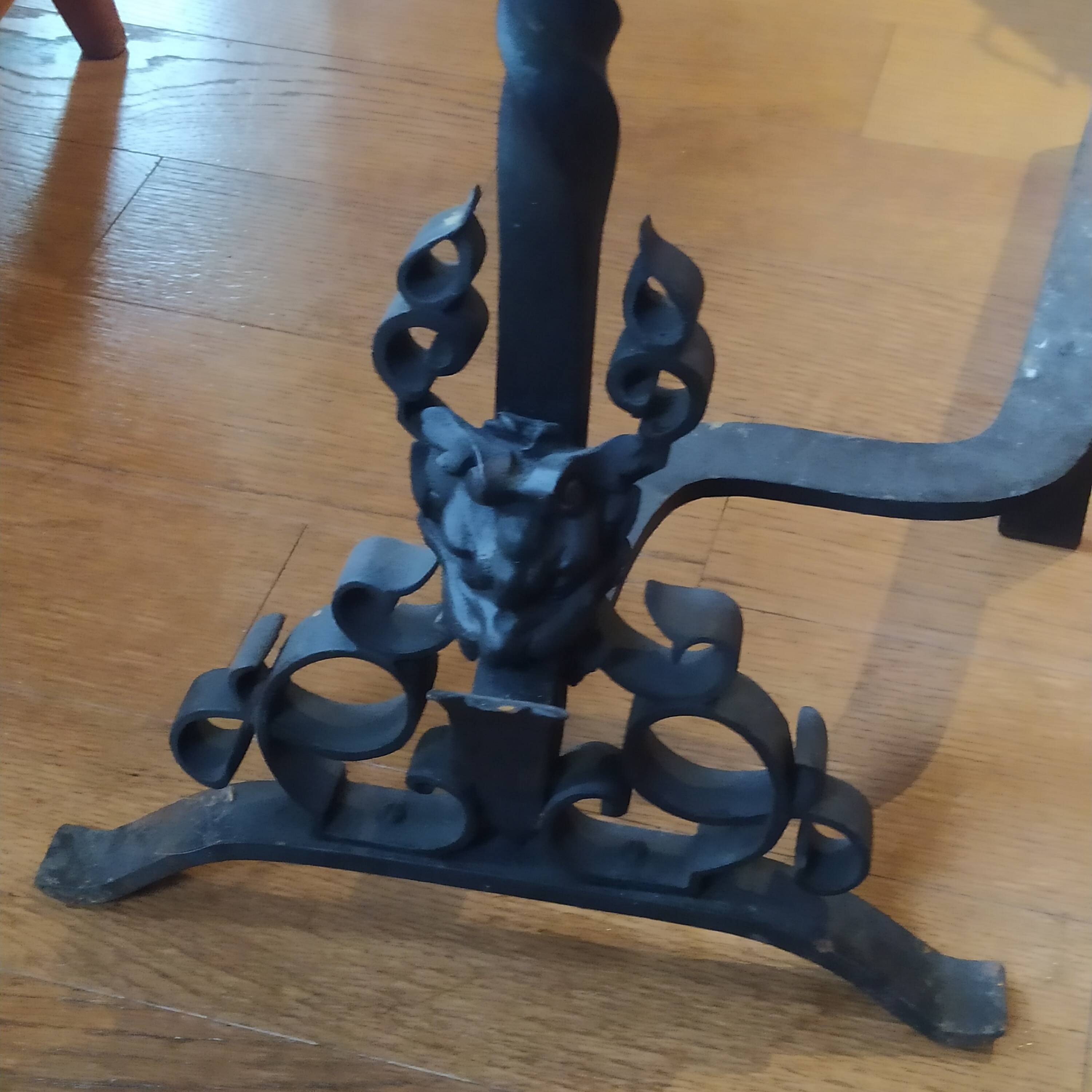 pair of large 20th century metal andirons with mascaron decoration