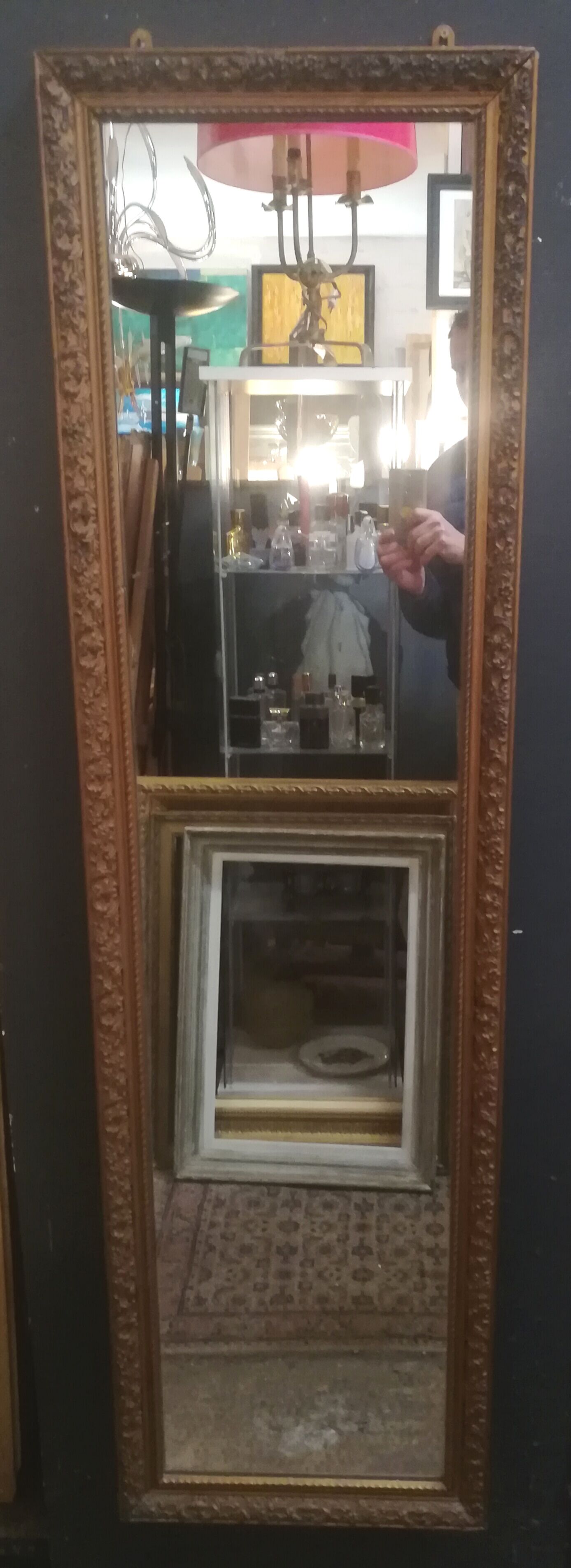 High and narrow mirror in gilded stucco late nineteenth century