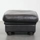 Set of a black cowhide leather Chesterfield armchair and matching ottoman