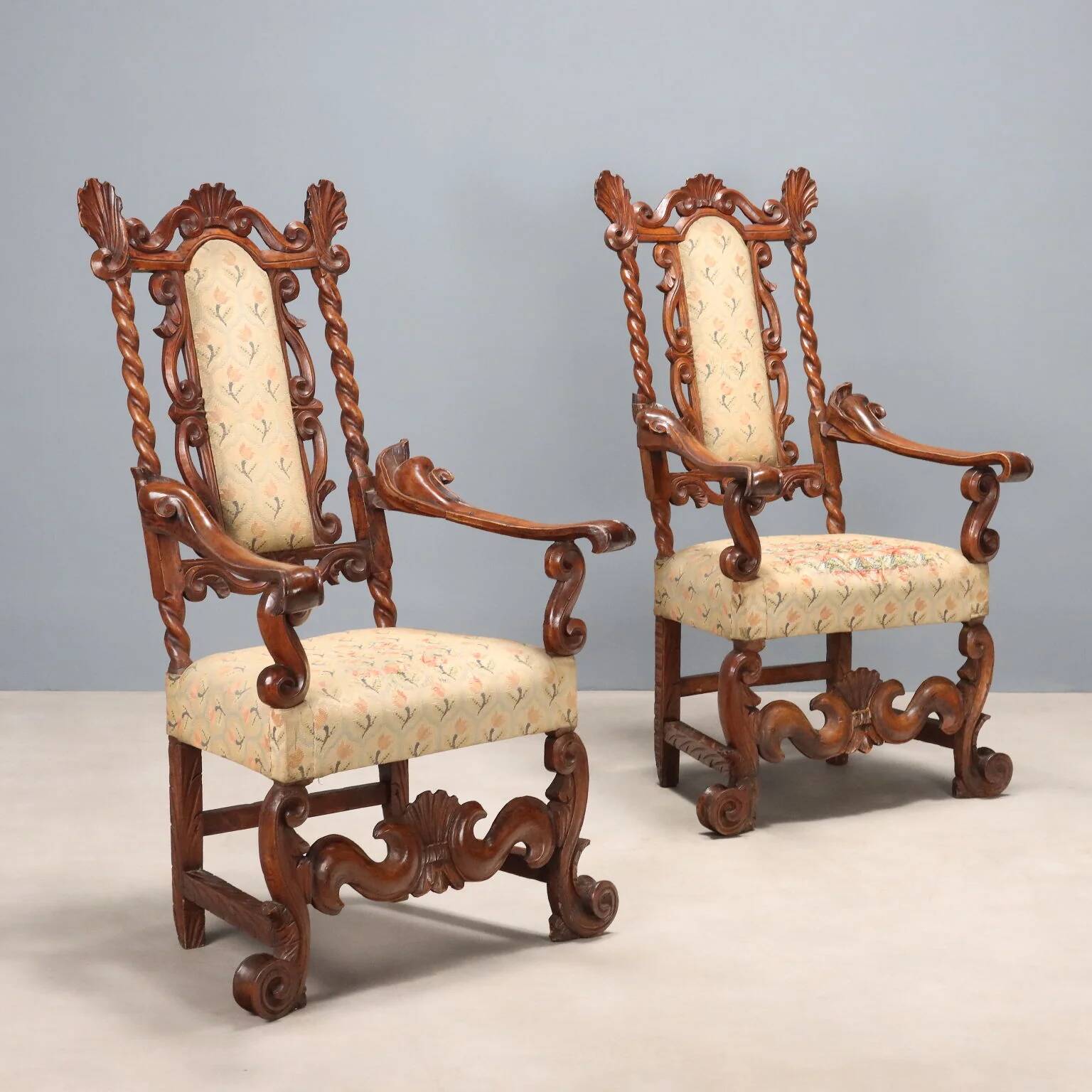Pair of antique Baroque armchairs in walnut and fabric, Italy, 17th century.