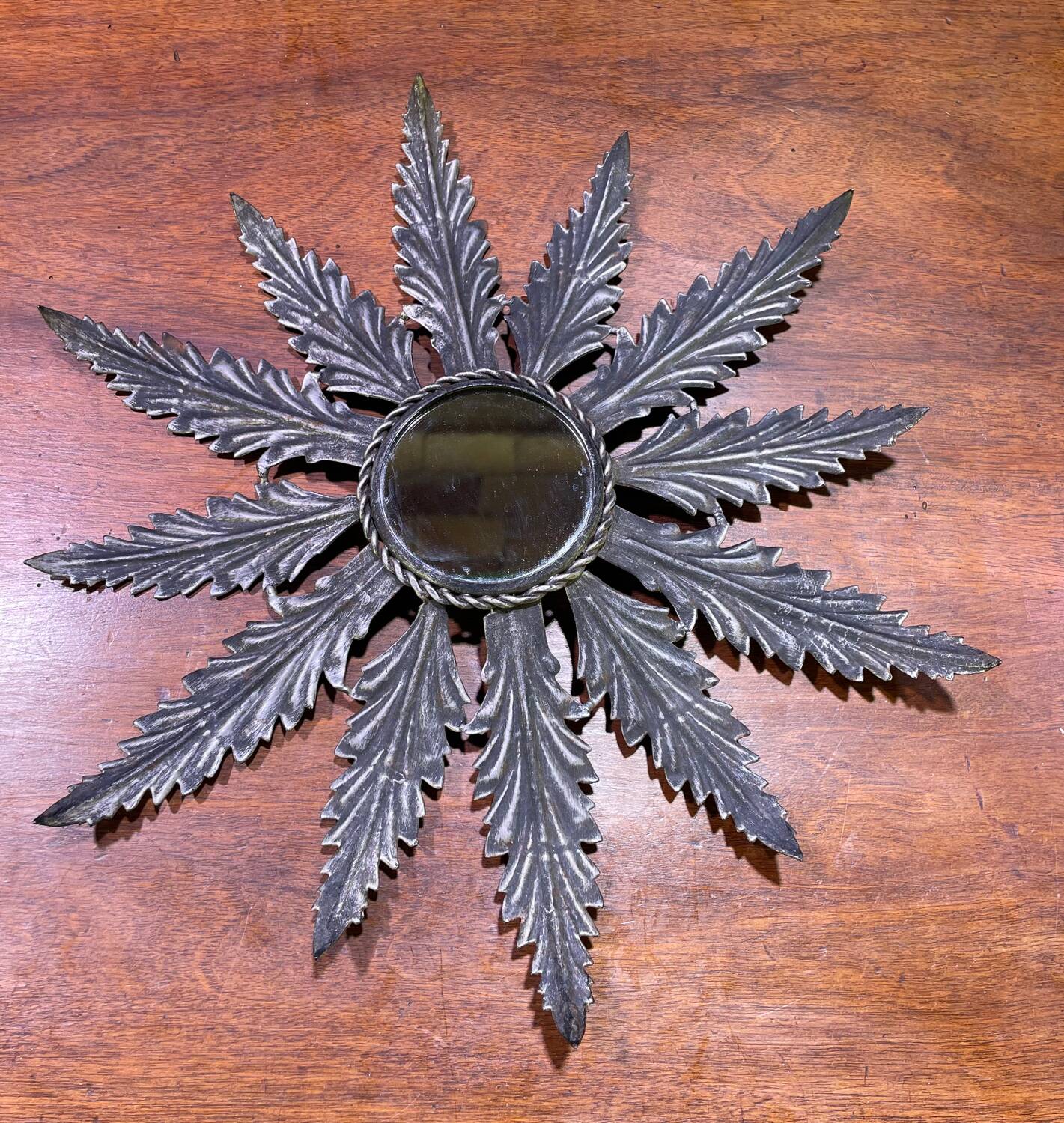 Metal mirror with foliage decoration
