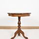 Pedestal table or side table, carved wooden legs, inlaid veneer on the top.