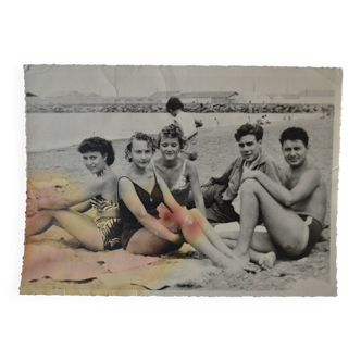 Old film photo circa 1950 the beach group of teenagers