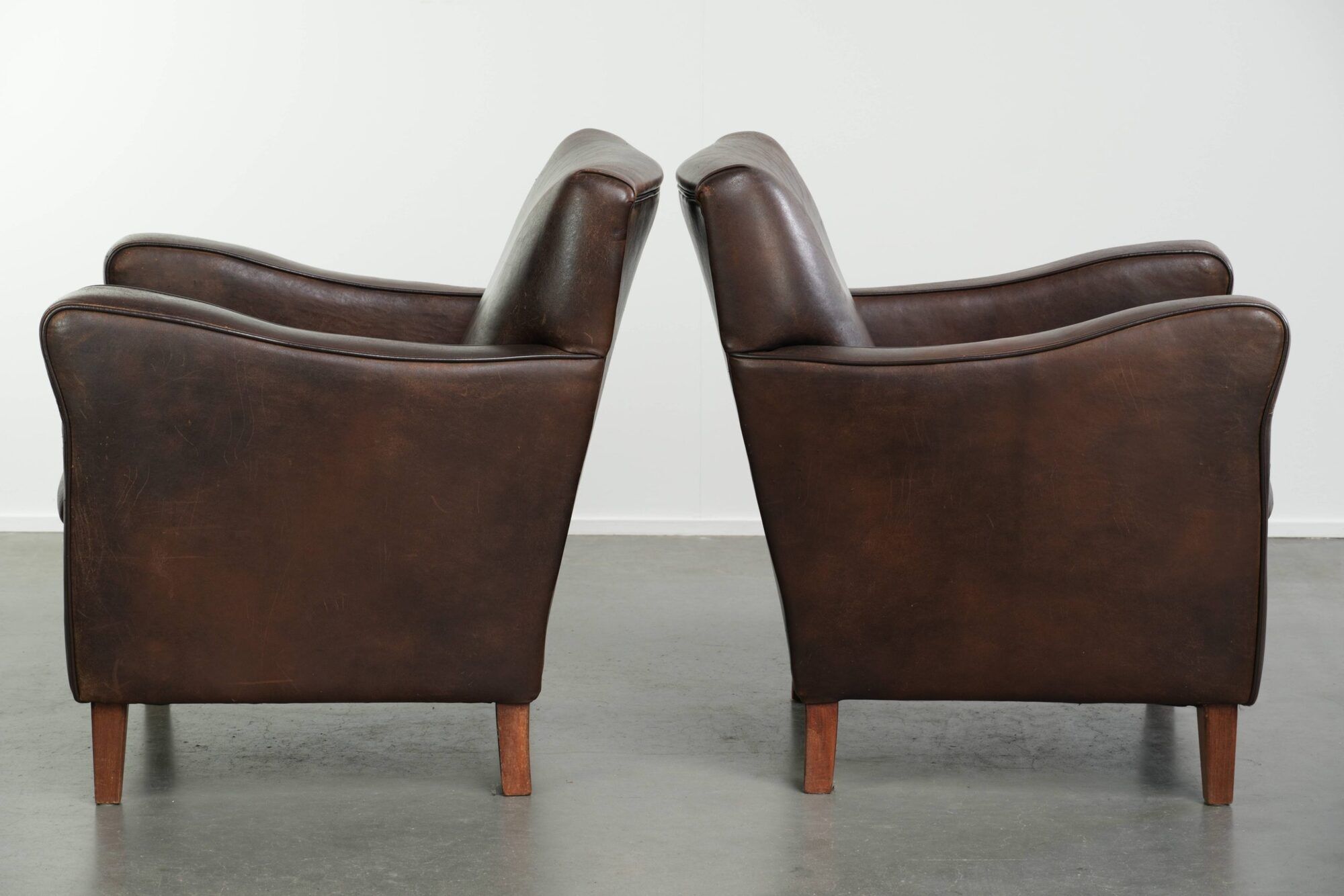 Sturdy set of vintage sheepskin armchairs in a beautiful dark colour
