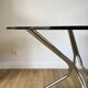 Set consisting of a table in chrome and smoked glass and its 4 tubular chairs in chrome and skaï a