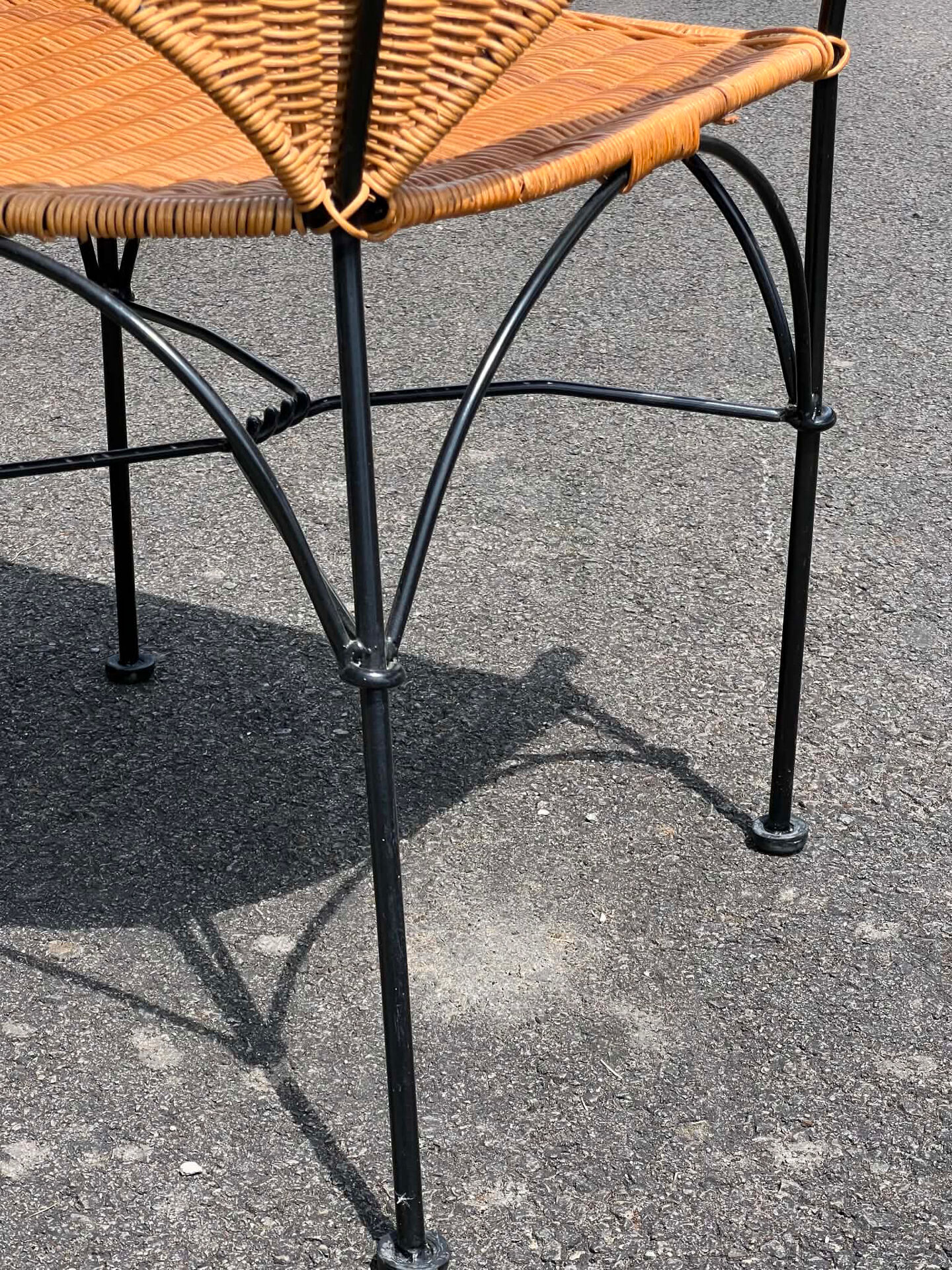 Wicker and black wrought iron armchair